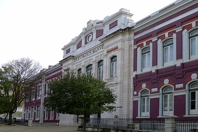 The neoclassical facade of Liceu Passos Manuel in Lisbon, with 'Lyceu Passos Manuel' carved above the entrance.